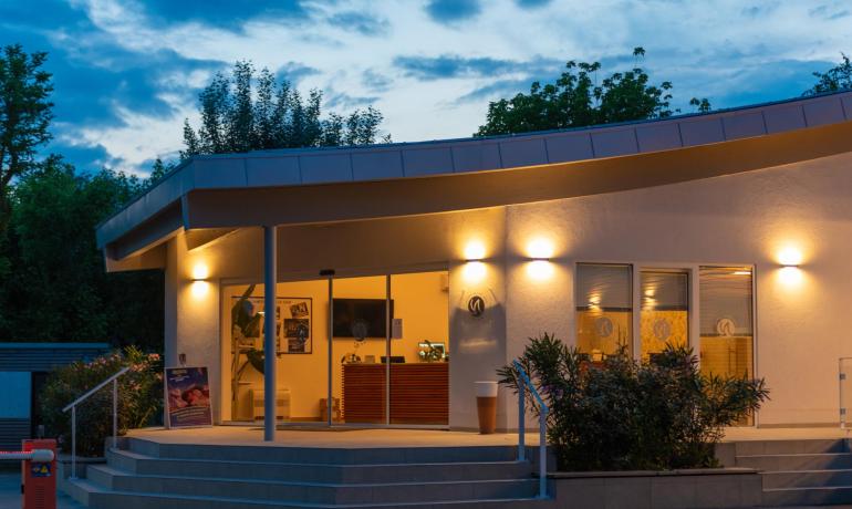 Modern building with lights on at dusk.